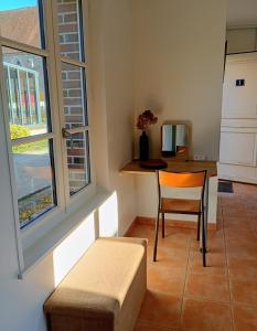a room with a table and a chair and a window at Le Clos du Perche in Boissy-lès-Perche +14 photos