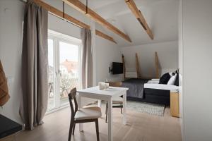a bedroom with a white table and chairs and a bed at L Boutique Hotel in Lysekil