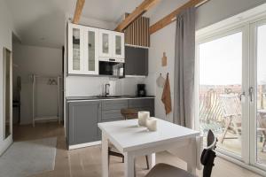 a kitchen with a white table and a white counter top at L Boutique Hotel in Lysekil