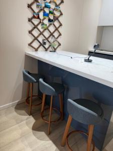 a kitchen with two stools at a counter at shunshig 11 in Ulaanbaatar +32 photos