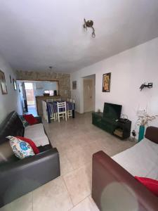 a living room with a couch and a table at Departamento duplex Pinamar in Pinamar