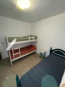 a bedroom with two bunk beds in a room at Departamento duplex Pinamar in Pinamar