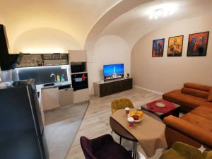 a living room with a couch and a table at Alma Apartment DOWNTOWN in Košice