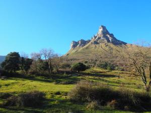 a mountain in the middle of a field at Arteondo in Mendeica +3 photos