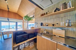 a kitchen with a sink and a counter top at プライベートリゾート清風 in Atami