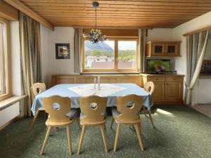a dining room with a table and chairs and a window at Chalet Cristall Superior Appartement 4 in Leutasch
