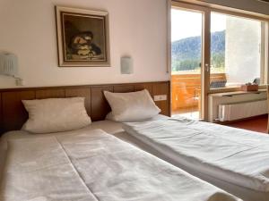 a large bed in a room with a large window at Chalet Cristall Superior Appartement 4 in Leutasch