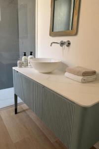 a bathroom with a sink and a mirror on a counter at Da Lorenzo Luxury Apartment in Bologna