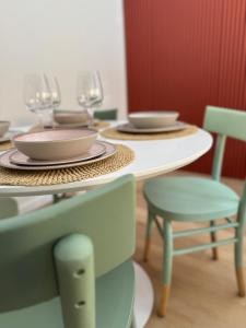 two tables with plates and wine glasses on them at Da Lorenzo Luxury Apartment in Bologna