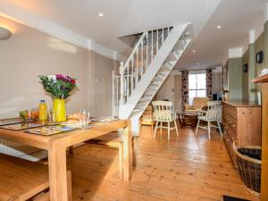 a living room with a wooden table and a staircase at 3 Bed in Whitstable oc-wcc07 in Whitstable