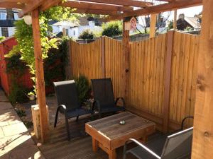 a patio with two chairs and a table and a fence at 3 Bed in Whitstable oc-wcc07 in Whitstable