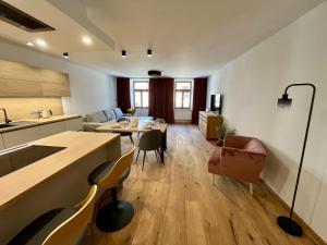 a kitchen and living room with a table and chairs at Core Apartments Jihlava in Jihlava