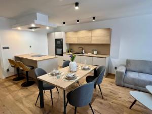 a kitchen and living room with a table and chairs at Core Apartments Jihlava in Jihlava