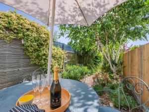 a bottle of champagne on a table under an umbrella at 3 Bed in Whitstable oc-wcc17 in Whitstable