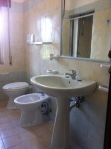 a bathroom with a sink and a toilet at Chalet Pineta Mare in Foce Varano +13 photos