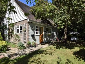 a small white house with a door in a yard at 1 Bed in Etchingham oc-62641 in Burwash