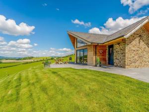 a stone house with a large lawn in front of it at 2 Bed in Montgomery oc-83243 in Llandyssil