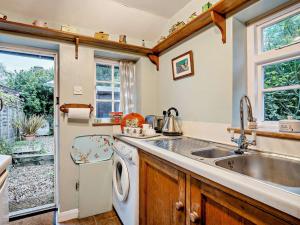 a kitchen with a sink and a washing machine at 1 Bed in Northiam oc-bt033 in Northiam +8 photos