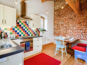 a kitchen with a table and a brick wall at 3 Bed in Norwich oc-owln8 in Corpusty +5 photos