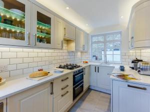 a kitchen with white cabinets and a stove top oven at 3 Bed in Whitstable oc-wcc12 in Whitstable