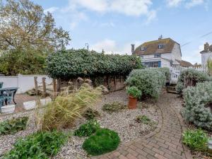 a garden with a brick path in front of a house at 3 Bed in Whitstable oc-wcc12 in Whitstable