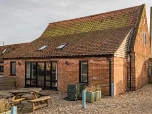 a brick building with a picnic table in front of it at 3 Bed in Briston oc-kt187 in Briston