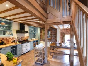 a kitchen with blue cabinets and a wooden floor at 3 Bed in Briston oc-kt187 in Briston