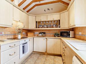 a kitchen with white cabinets and a coffered ceiling at 2 Bed in Dereham oc-57133 in Mattishall