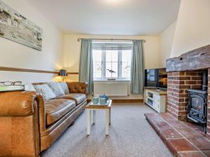 a living room with a couch and a fireplace at 3 Bed in Kings Lynn oc-65596 in Heacham