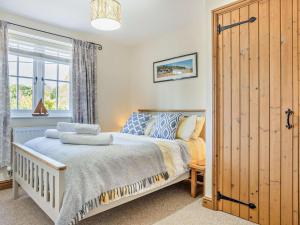 a bedroom with a bed and a large window at 3 Bed in Kings Lynn oc-65596 in Heacham