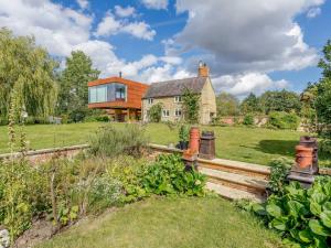 a house on a field with a garden at 1 Bed in Bedford oc-79095 in Turvey