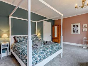 a bedroom with a large bed with a canopy at 3 Bed in Skegness oc-83461 in Wainfleet All Saints