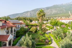 a view of a town with mountains in the background at Gokcen Hotel & Apartments in Oludeniz