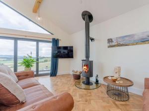 a living room with a couch and a fireplace at 3 Bed in Montgomery oc-88641 in Llandyssil