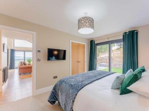 a bedroom with a bed and a large window at 3 Bed in Montgomery oc-88641 in Llandyssil