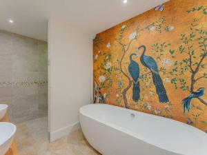a bathroom with a painting of birds on the wall at 3 Bed in Montgomery oc-88641 in Llandyssil +40 photos