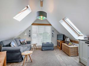 a living room with a couch and a table at 1 Bed in North Walsham oc-48723 in Bacton