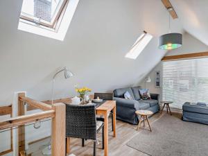 a living room with a table and a couch at 1 Bed in North Walsham oc-48723 in Bacton