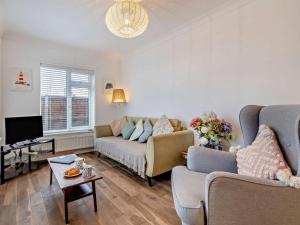 a living room with a couch and a tv at 2 Bed in Norwich oc-75392 in Bacton