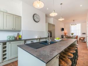 a kitchen with a counter with a clock on the wall at 5 Bed in Margate oc-86551 in Margate