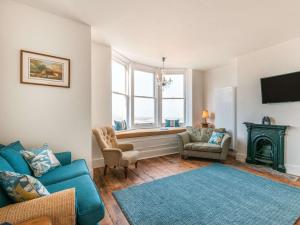 a living room with a blue couch and a window at 5 Bed in Margate oc-86551 in Margate