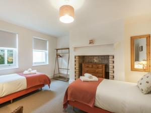 a bedroom with two beds and a fireplace at 5 Bed in Margate oc-86551 in Margate
