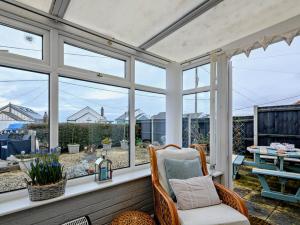 a screened in porch with a chair and windows at 2 Bed in Norwich oc-81322 in Walcott