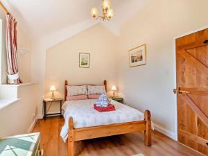 a bedroom with a bed and two lamps and a door at 1 Bed in Tunbridge Wells oc-79180 in Wadhurst