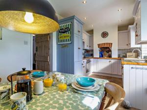a kitchen with a table with plates and bowls on it at 2 Bed in Shereford oc-kt156 in Tatterford