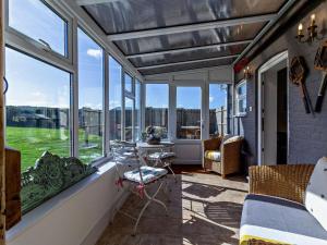 a screened in porch with a view of the yard at 2 Bed in Shereford oc-kt156 in Tatterford
