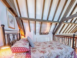a bedroom with a bed and a wooden ceiling at 3 Bed in Kings Lynn oc-75673 in Tattersett