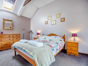 a bedroom with a bed and a dresser and a mirror at 2 Bed in Louth oc-74152 in North Somercotes