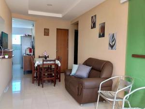 a living room with a couch and a table at Apartmento em Carapibus in Conde