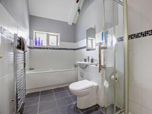 a bathroom with a toilet and a sink and a shower at 2 Bed in Louth oc-74152 in North Somercotes +14 photos